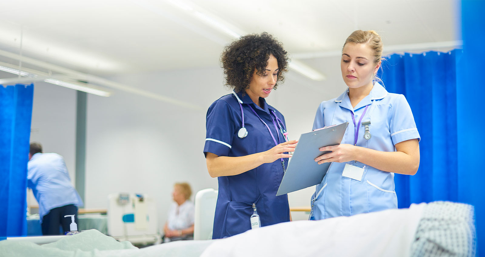 Nurse and physician review patient chart together in a hospital setting.