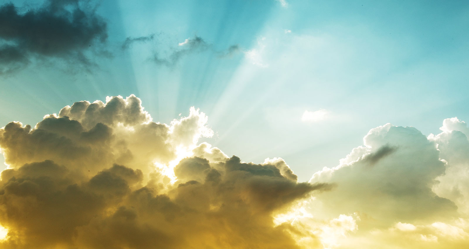 Sunbeams cut through a thick cloud creating a spiritually inspiring image.