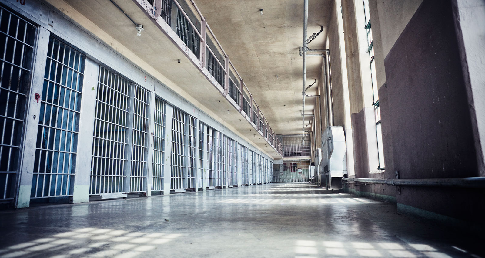 Hallway of a prison with cells that could benefit from criminal justice reform.