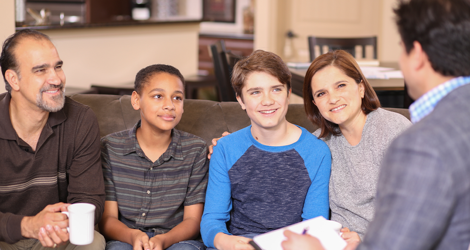 A diverse group of children and adults sitting on a couch