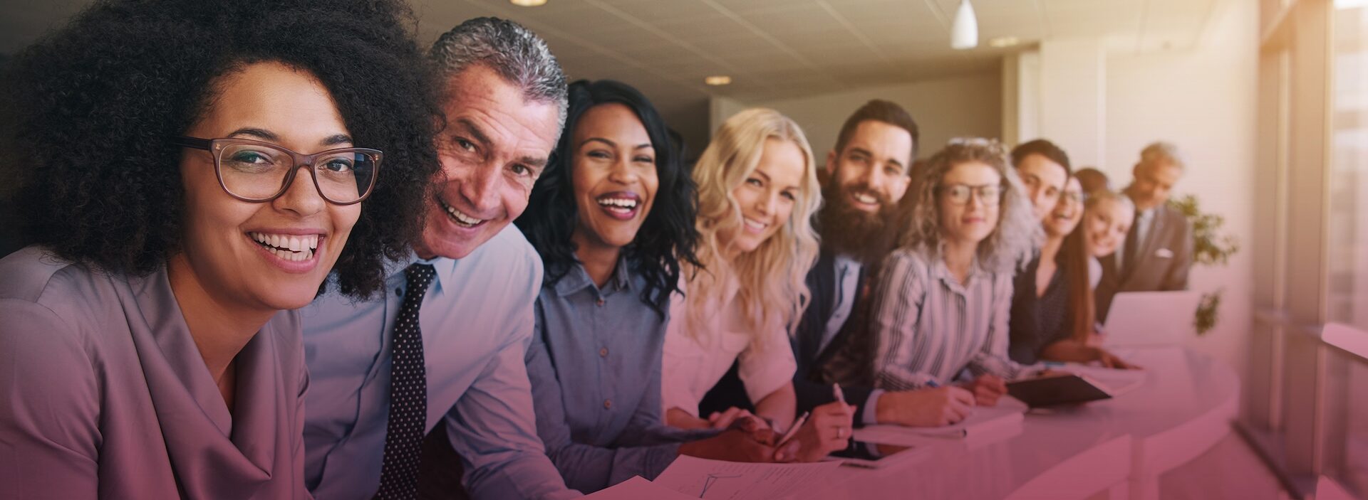 group of professional men and women leaning against counter