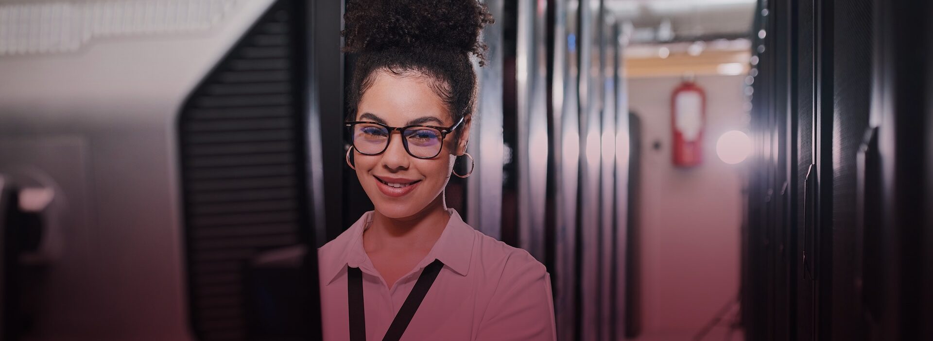 young woman in glasses looking at a computer monitor