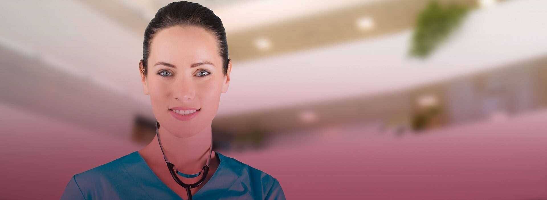 smiling nurse in scrubs wearing stethoscope around neck