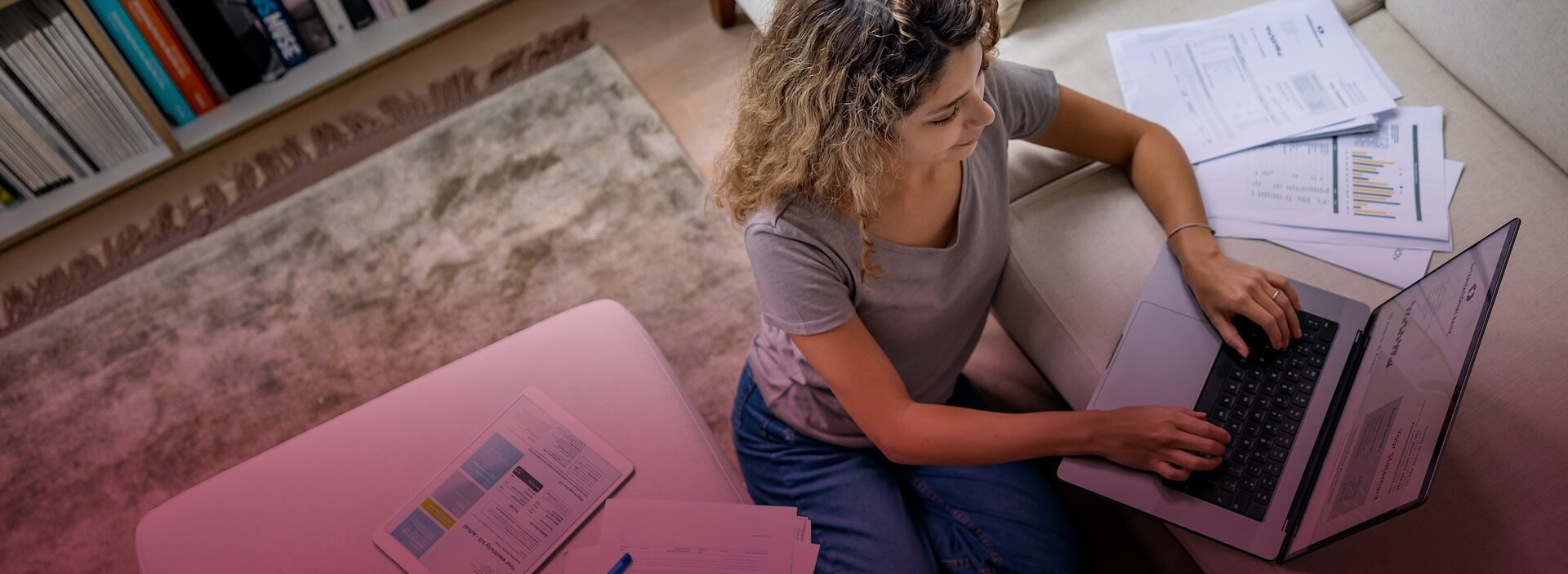 woman sitting at table doing homework on laptop