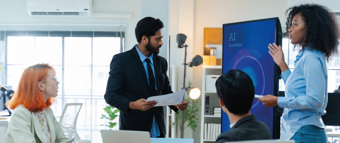 Coworkers discussing AI assistant tool during an office meeting presentation