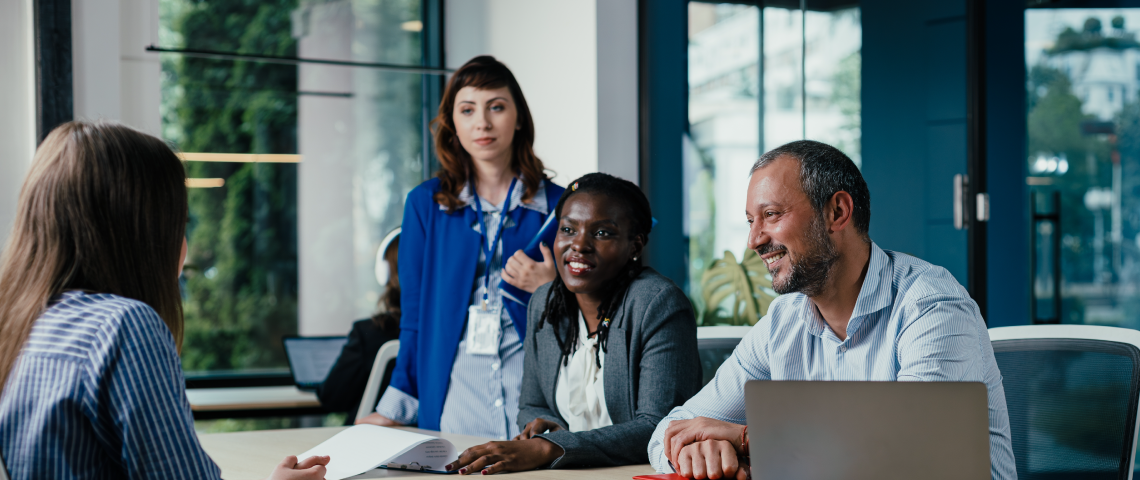 Diverse office team discussing documents in a bright meeting room