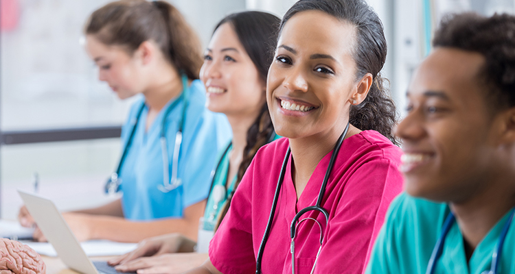 Nurses study side by side in a classroom setting.